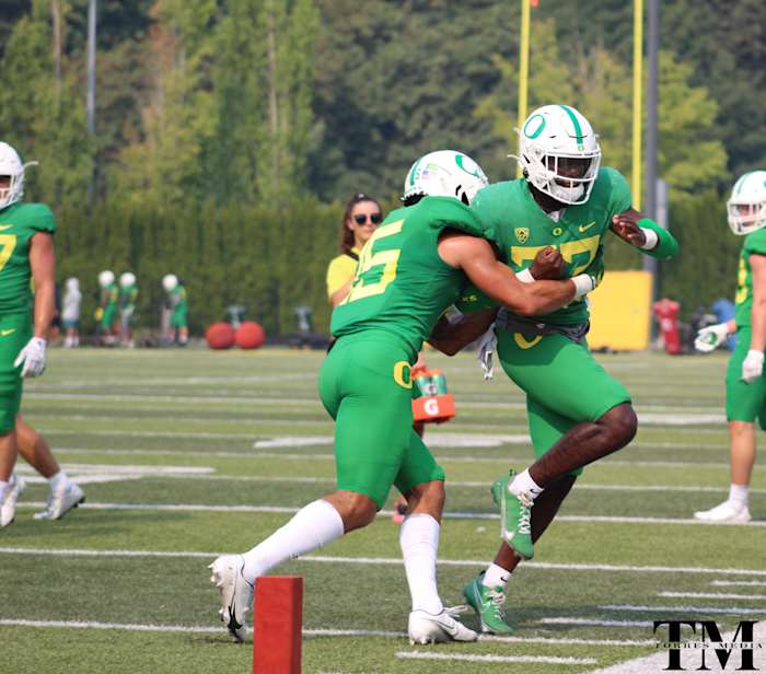 Bennett Williams wraps up Verone McKinley III in tackling drills.